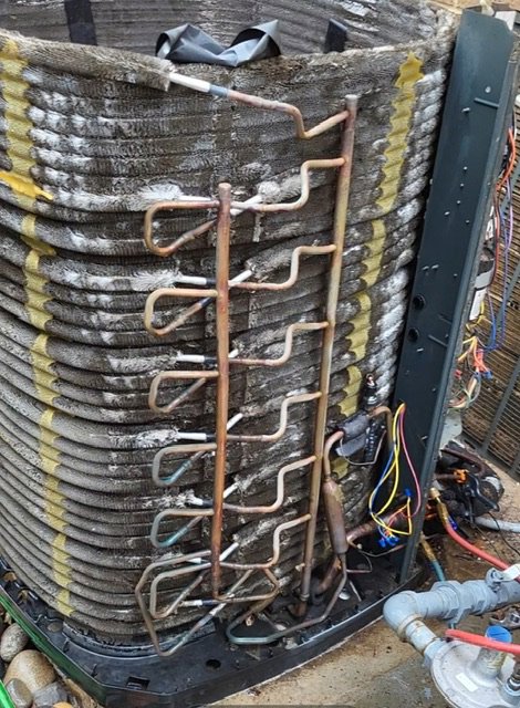 Internal components of an outdoor HVAC unit, including coils and wiring, being repaired by Modern Air Services in Fort Worth, TX.