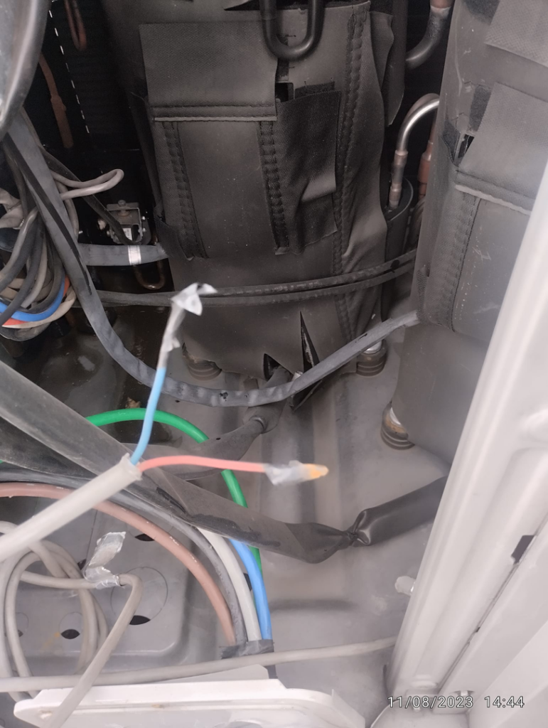 Close-up of internal components, wiring, and pipes within an HVAC unit by Facilityfix technicians in Port Harcourt, NG.