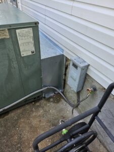 An outdoor HVAC unit undergoing maintenance or cleaning with a pressure washer by Parker's Heating & Cooling in Murfreesboro, TN