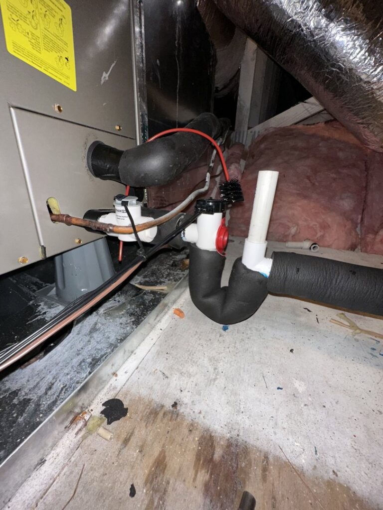 HVAC unit components including insulated lines and a condensate trap during maintenance by Love HVAC LLC in Bluffton, SC.