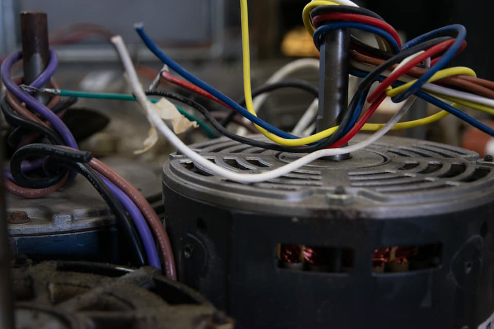 Close-up of an HVAC unit motor and electrical wiring, indicating repair work by AirTemp Heating & Cooling in Nashville, TN.