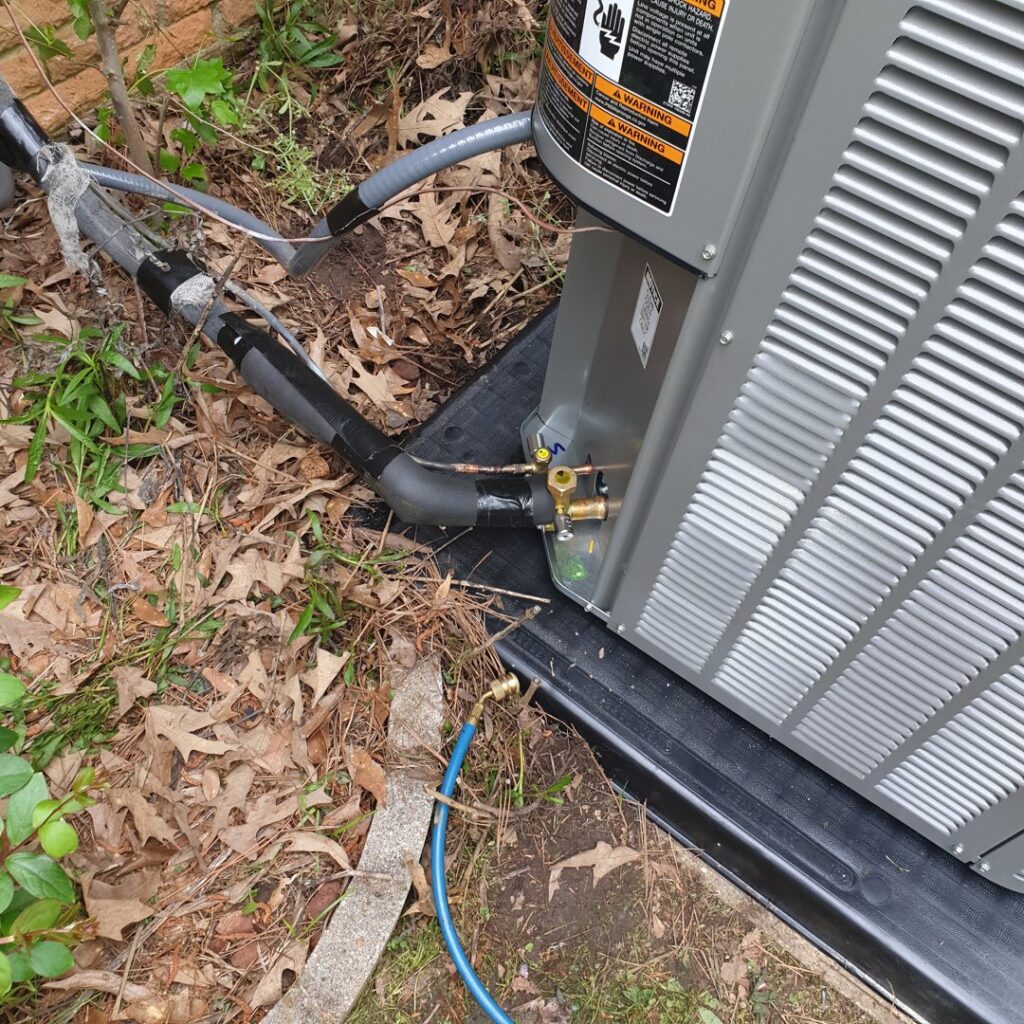 Close-up of an outdoor HVAC unit's refrigerant lines being serviced by Home Shield Heating and Air in Shreveport, LA.