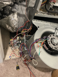 Inside of an HVAC unit showing exposed wiring and a blower fan during a repair by Nashville Heating & Air in Gallatin, TN