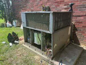 An outdoor HVAC unit with panels removed for repair or maintenance by Comfort Zone Mechanical in Antioch, TN.