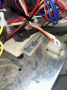 Close-up of internal wiring and a Trane label inside an HVAC unit during an inspection by A/C Company Since 1988 in Murfreesboro, TN.