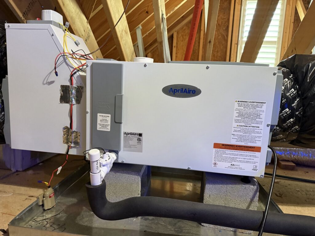An outdoor HVAC unit with diagnostic gauges connected during a service call by Reliable Heating and Air in Knightdale, NC