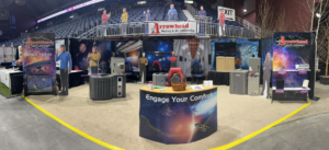 An Arrowhead Heating & Air Conditioning trade show booth displaying various HVAC units and services in Casper, WY.
