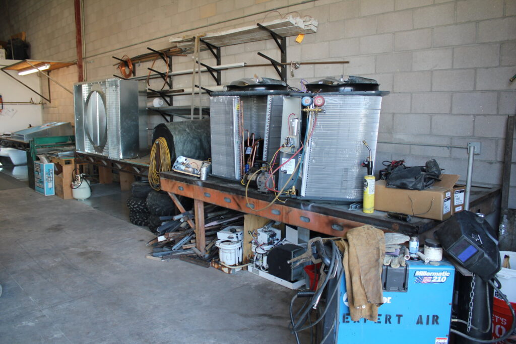 HVAC units and tools on a workbench at Expert Air Conditioning & Heating's facility in Las Vegas, NV.