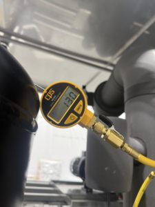 A close-up of an HVAC vacuum gauge showing a reading of 13.0 units, used by KCC Mechanical, LLC in Sandy, UT.