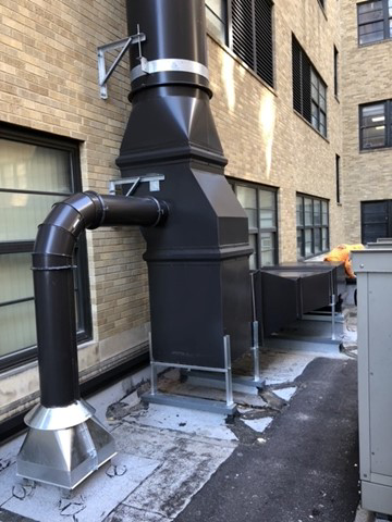 HVAC vertical stack with a curved pipe connection and horizontal ductwork installed by Kuhlmann Supply Company in Earth City, MO
