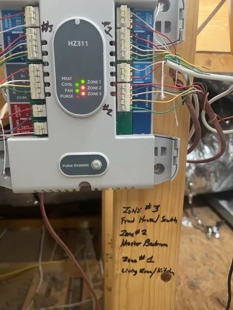 A close-up of an HVAC zone control panel with intricate wiring, serviced by Ault's Cooling HVAC Services LLC in Chandler, AZ.