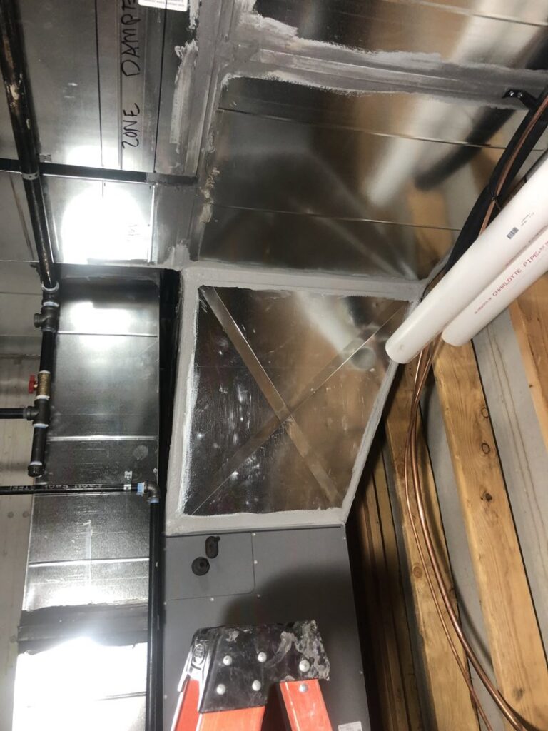Close-up of HVAC zone damper and metal ductwork installation by Cutting Edge HVAC LLC in Orem, UT.