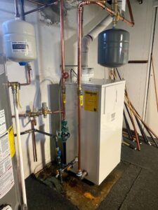 A hydronic heating boiler system with copper piping and expansion tanks installed by Grozier Heating and Air Conditioning, LLC in Allentown, PA.