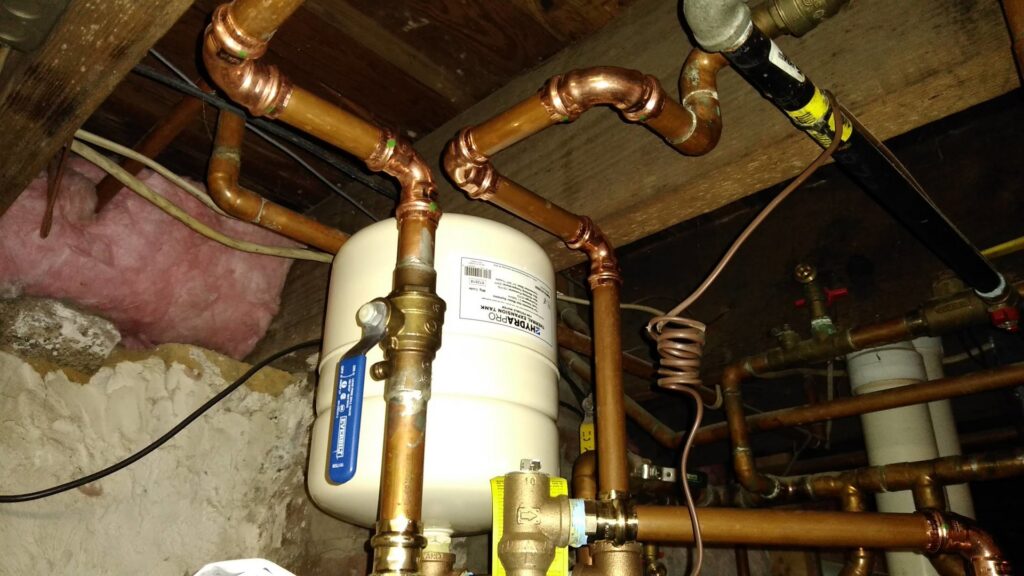 An expansion tank and copper piping, part of a hydronic heating system installation by MBI Heating and Air Conditioning in Allentown, PA.