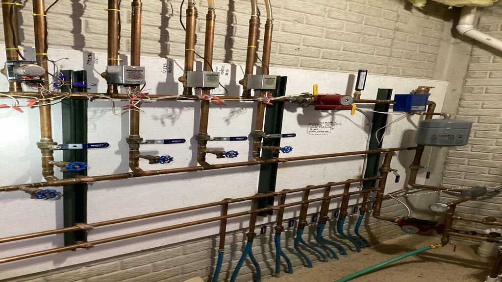 A complex hydronic heating manifold system with copper pipes and valves installed by Terry Allen Plumbing & Heating in Flint, MI.