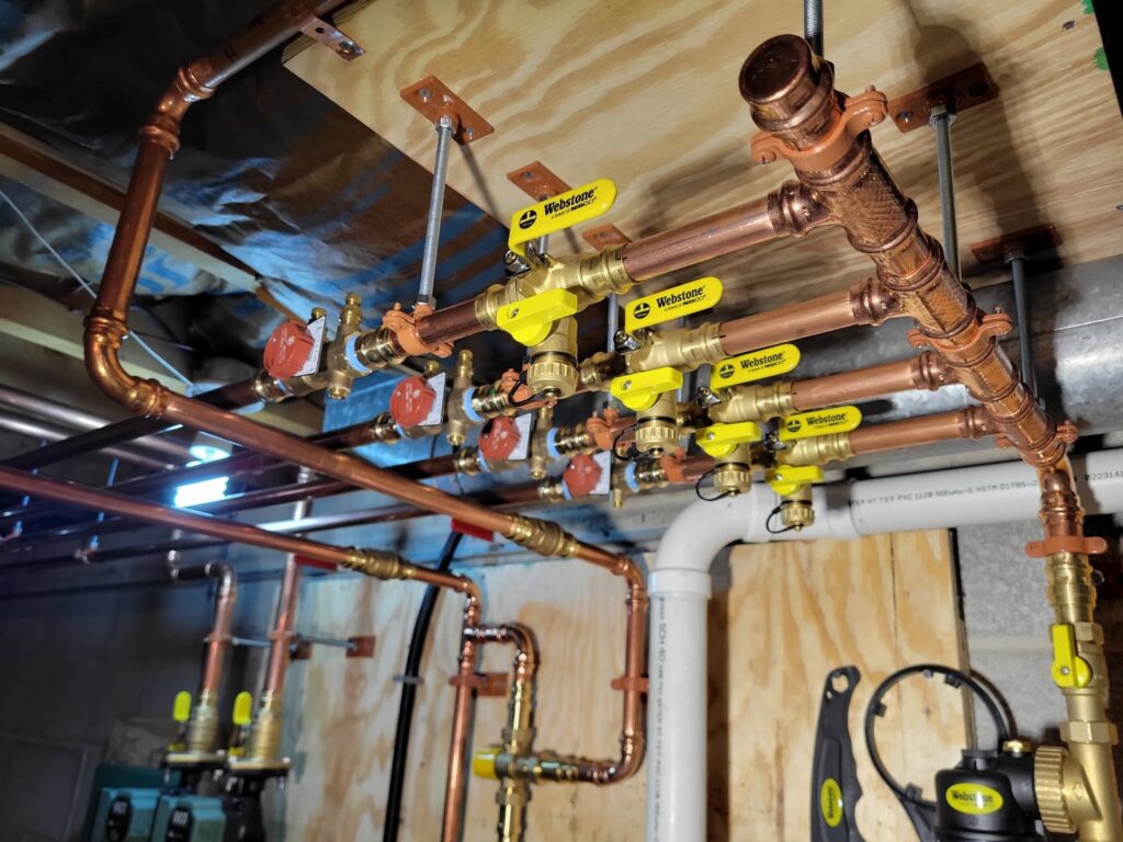 A complex hydronic heating piping manifold installed by Complete Mechanical Solutions in Novi, MI.