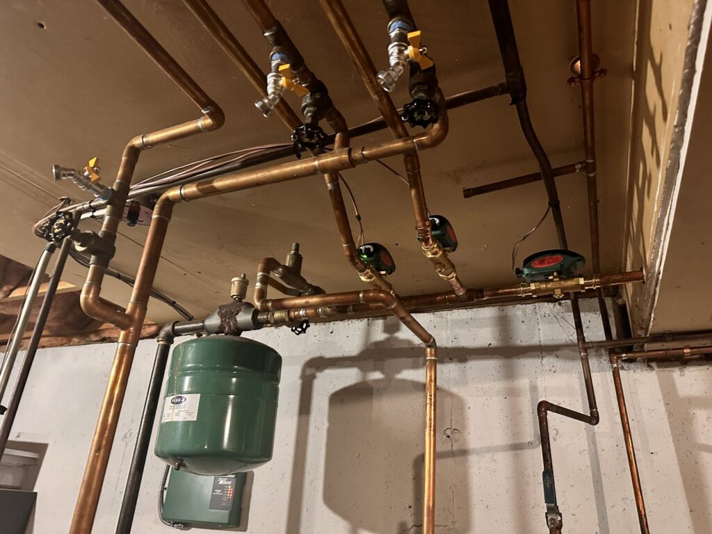 A newly installed hydronic heating or plumbing piping system with expansion tanks by Advanced Comfort LLC in Concord, NH.