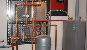 A hydronic heating system with copper piping and control panels installed by Pugh Heating & Air Conditioning in Holland, OH.