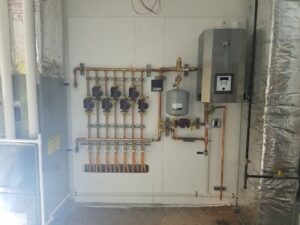 A hydronic heating system with copper piping and pumps installed by Advantage Mechanical, Inc. in Appleton, WI.