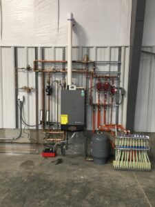 A complex hydronic heating system installation with boiler and manifold by Comforttechs in Lincoln, NE.