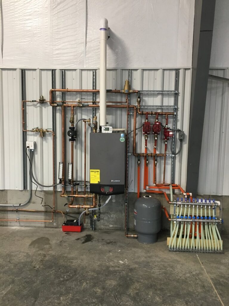 A complex hydronic heating system installation with boiler and manifold by Comforttechs in Lincoln, NE.