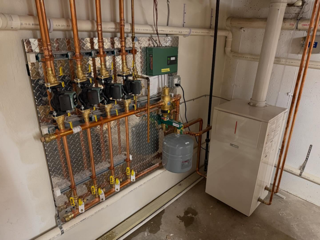 A newly installed hydronic heating system with copper piping and pumps by PureTemp Heating and Cooling in Salem, NH.
