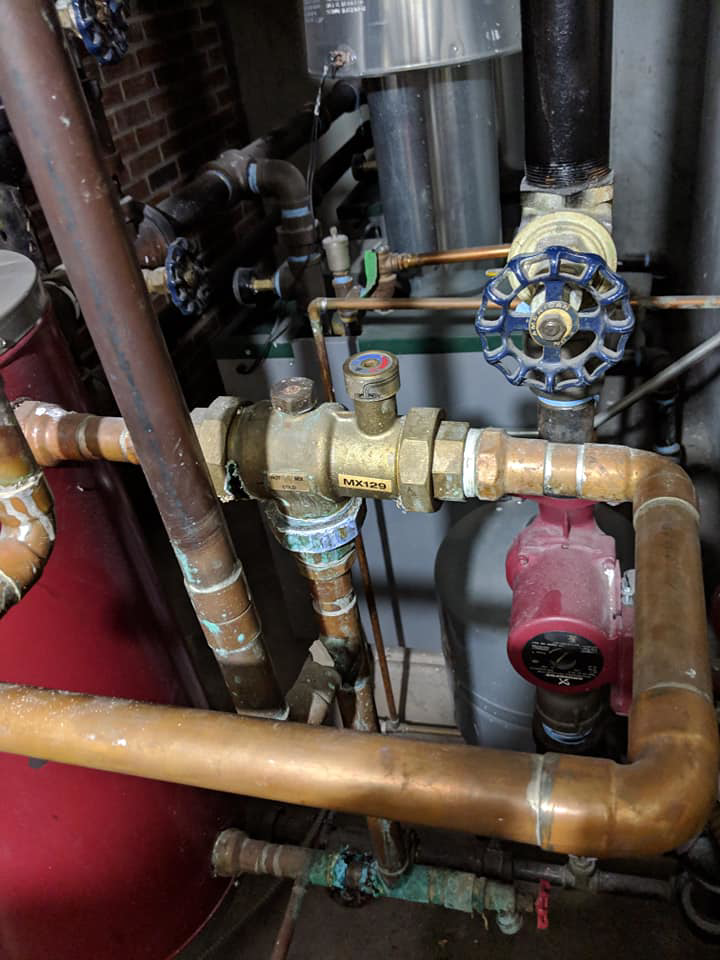 Detailed view of hydronic heating system piping and valves installed by A&T Mechanical in Edmond, OK