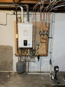 A comprehensive hydronic heating system with a tankless water heater and extensive piping installed by MTL Heating and Cooling LLC in West Haven, CT