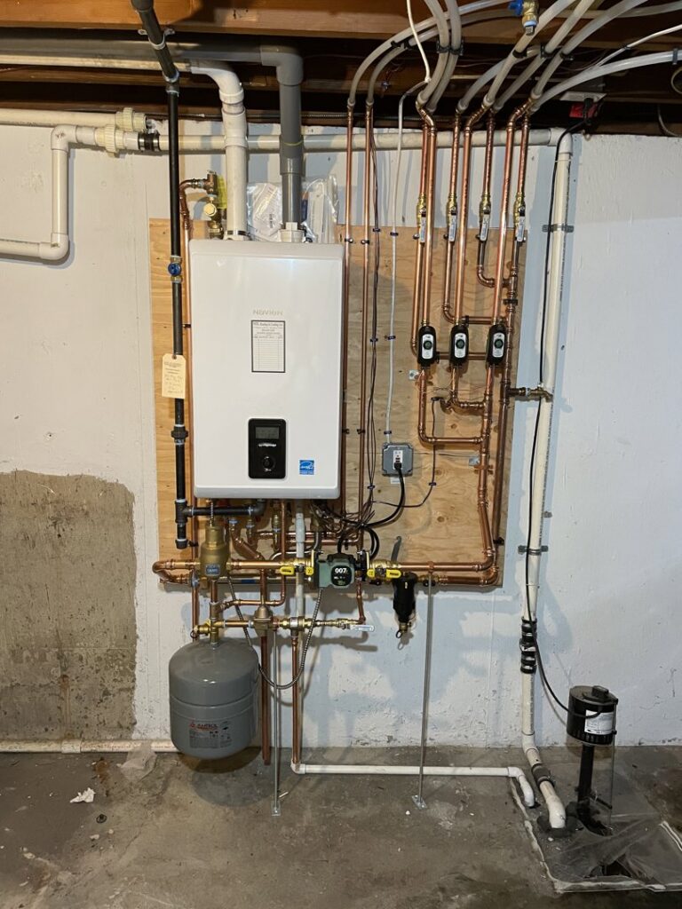 A comprehensive hydronic heating system with a tankless water heater and extensive piping installed by MTL Heating and Cooling LLC in West Haven, CT