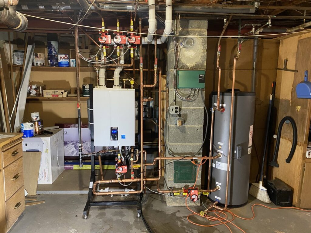A complex hydronic heating system with a tankless water heater and copper piping installed by Nordic Air Heating & Cooling in West Allis, WI.