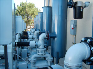 Hydronic HVAC system installation with copper piping and red pumps by American Mechanical Corp in Caldwell, ID
