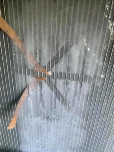 An iced HVAC coil with debris, showing a system in need of repair by Thomas HVAC LLC in Huntsville, AL
