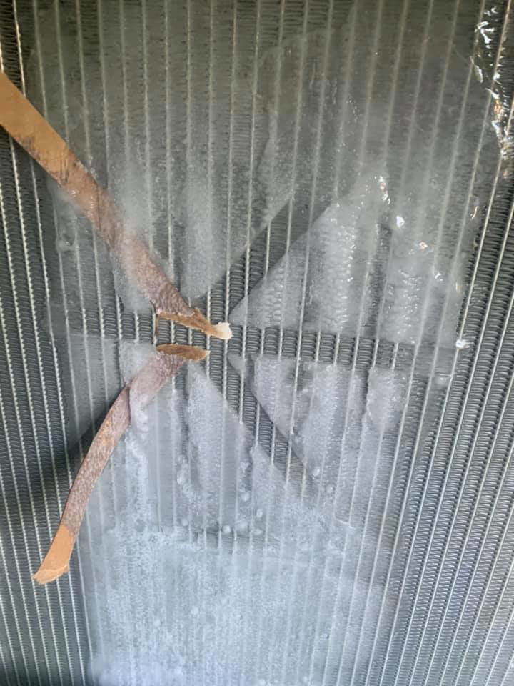 An iced HVAC coil with debris, showing a system in need of repair by Thomas HVAC LLC in Huntsville, AL