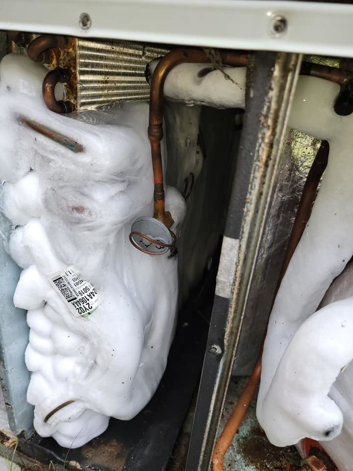 Iced-up HVAC evaporator coils inside a unit, indicating a service need by HD Mechanical Services in Buena Park, CA