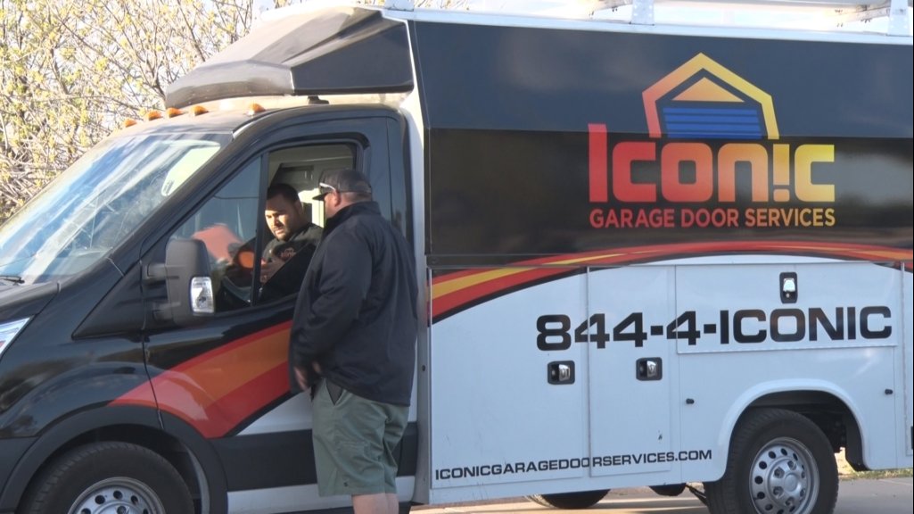 Iconic Garage Door Service technicians with their branded service van in Queen Creek, AZ.
