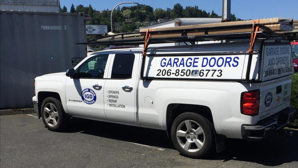 The IGD Garage Door Repair company truck with branding and contact information, serving clients in Renton, WA.