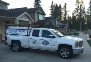 An IGD Garage Door Repair service truck parked in a residential area, ready for garage door services in Renton, WA.