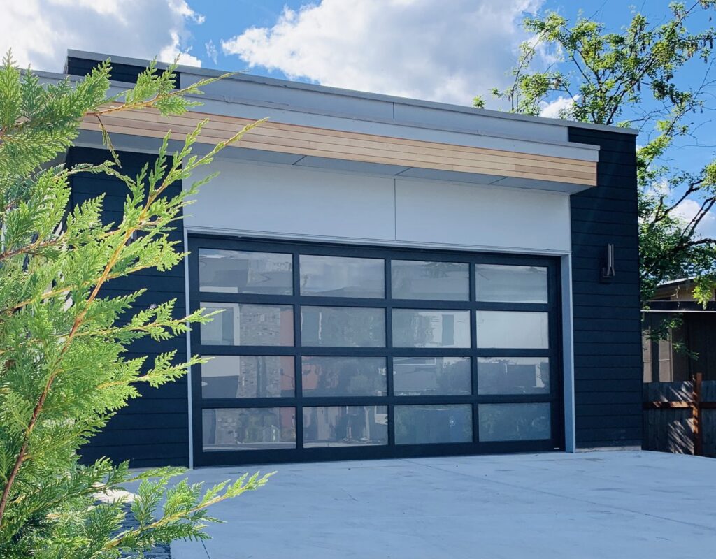 The IGD Garage Door Repair team on a job site with service trucks and equipment, preparing for a garage door installation or repair in Renton, WA.