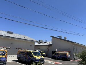 Ignitify Commercial Grade HVAC vans parked outside a commercial building with rooftop HVAC units in El Paso, TX.