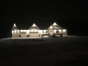 Fully illuminated house exterior lighting at night in snow by Alien Electric Inc. in Dayton, OH.