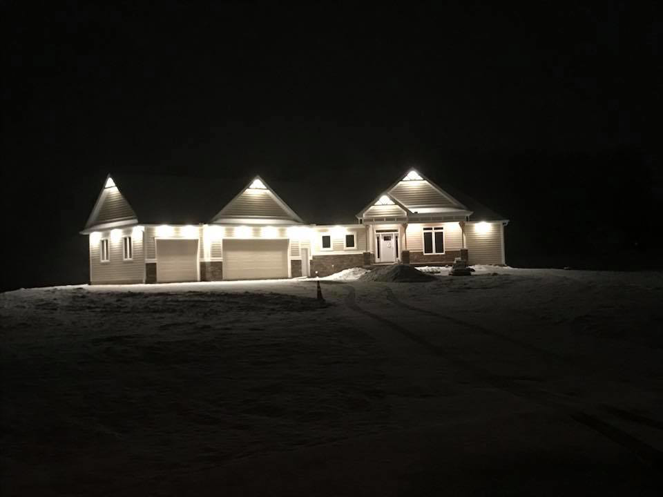 Fully illuminated house exterior lighting at night in snow by Alien Electric Inc. in Dayton, OH.