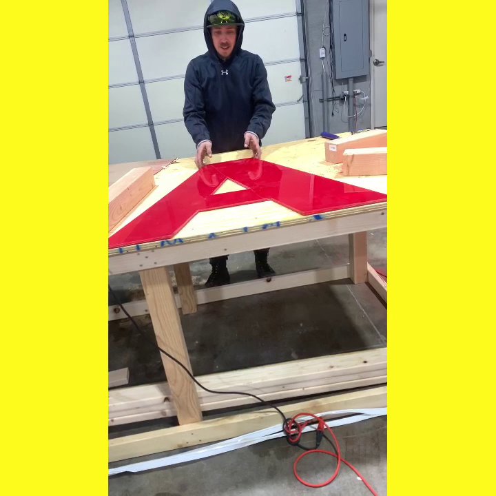 An electrician from Lumenus Technologies, LLC fabricating an illuminated sign in Lenexa, KS.