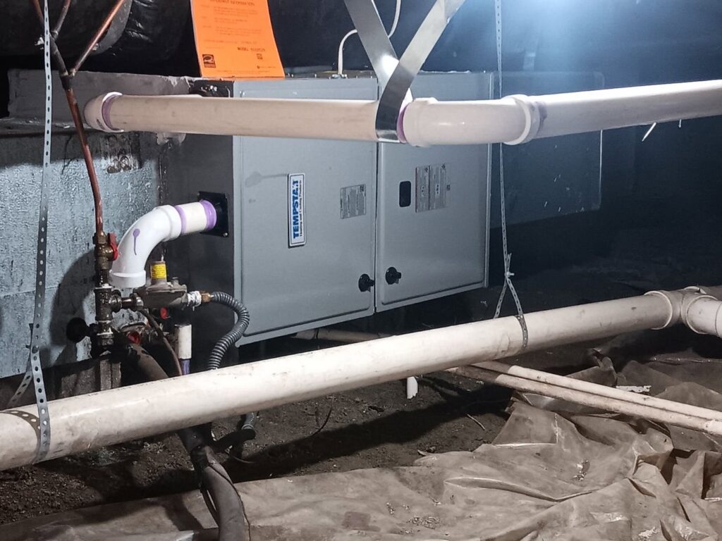 An indoor air handler unit with connected ductwork installed by Honesty Services in Rock Hill, SC.