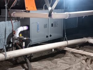 An indoor air handler unit with connected ductwork installed by Honesty Services in Rock Hill, SC.