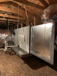 An indoor air handler unit and ductwork installed in an attic space by Valle Del Sol Home Services, LLC in Scottsdale, AZ.