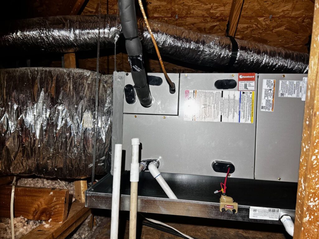 Indoor air handler unit installed in an attic with connected ductwork by Benavidez Heating & Air Conditioning In, Arlington, TX.