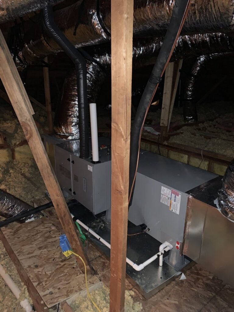 An indoor air handler unit and ductwork installed in an attic by Trinity Climate Control in Clayton, NC.