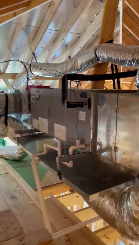 An indoor air handler unit connected to extensive ductwork in an attic, installed by Jupitair in Frisco, TX.