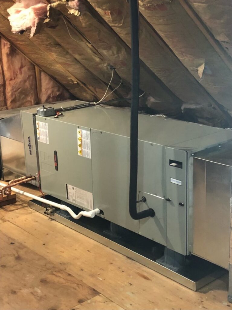 An indoor air handler or furnace unit installed in an attic space by Climate Care Heating & Air Conditioning in Norwalk, CT