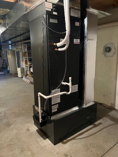 A modern black indoor air handler and furnace unit installed by Tapper Energy in Dauphin, PA.